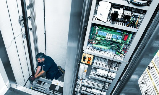 a man fixing a lift